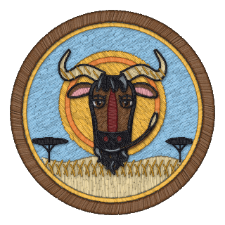 Free software badge: a laid-back gnu chewing grass before the setting sun